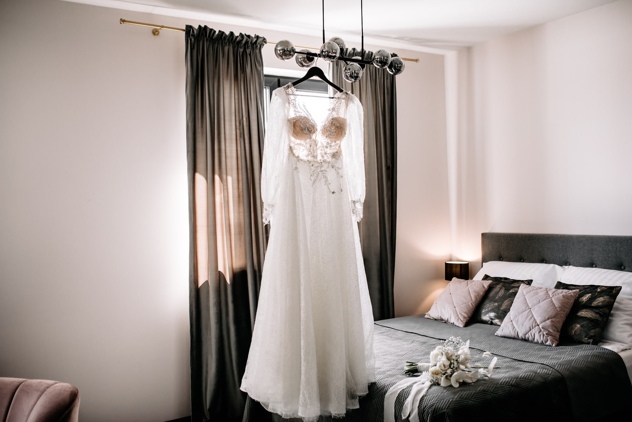 A wedding dress hanging in the hotel room