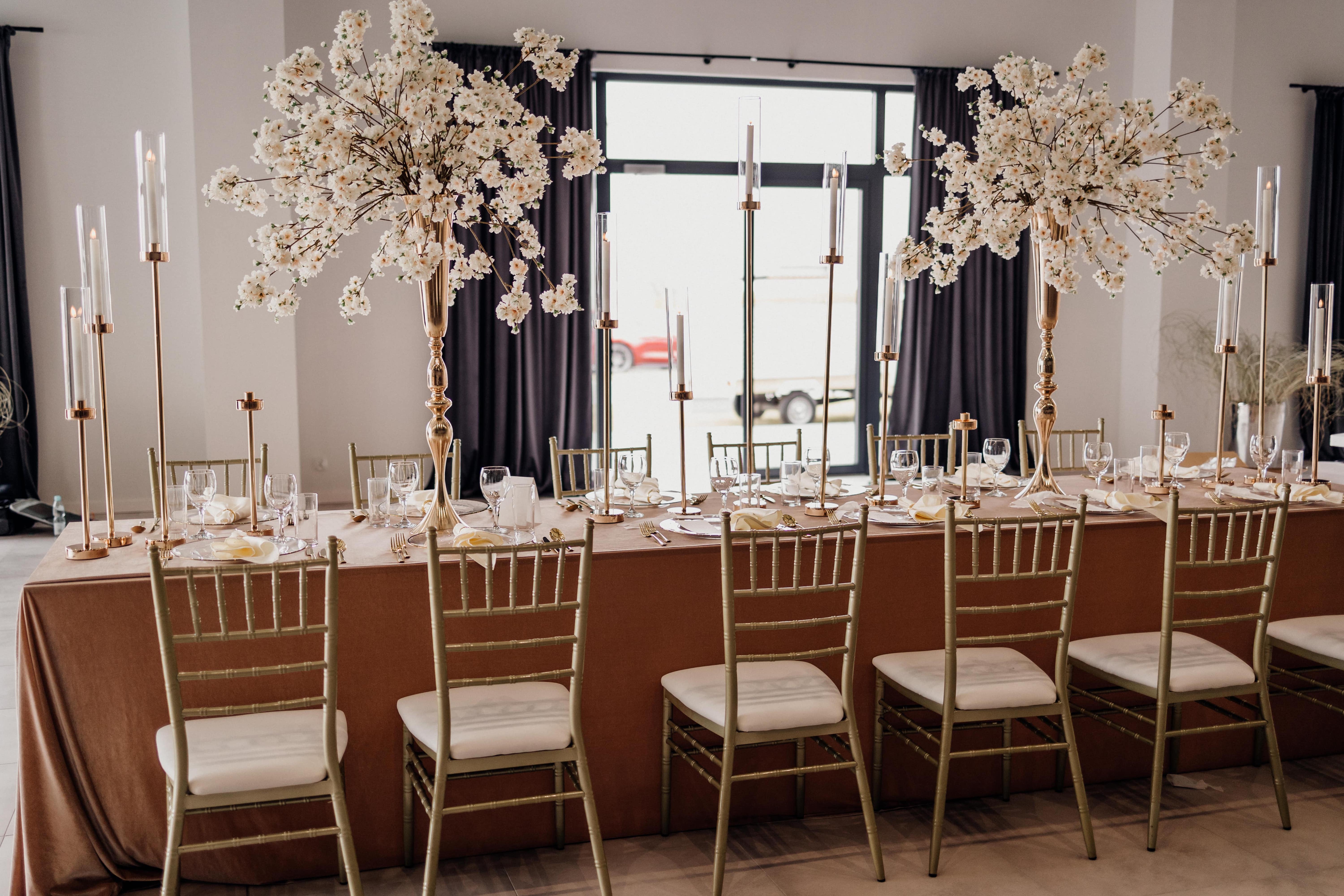 A drcorated wedding room with table and chairs